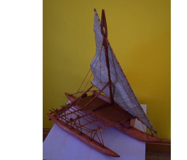 A scale model of a Fijian Drua, the traditional double-hulled voyaging canoe with a pandanus sail