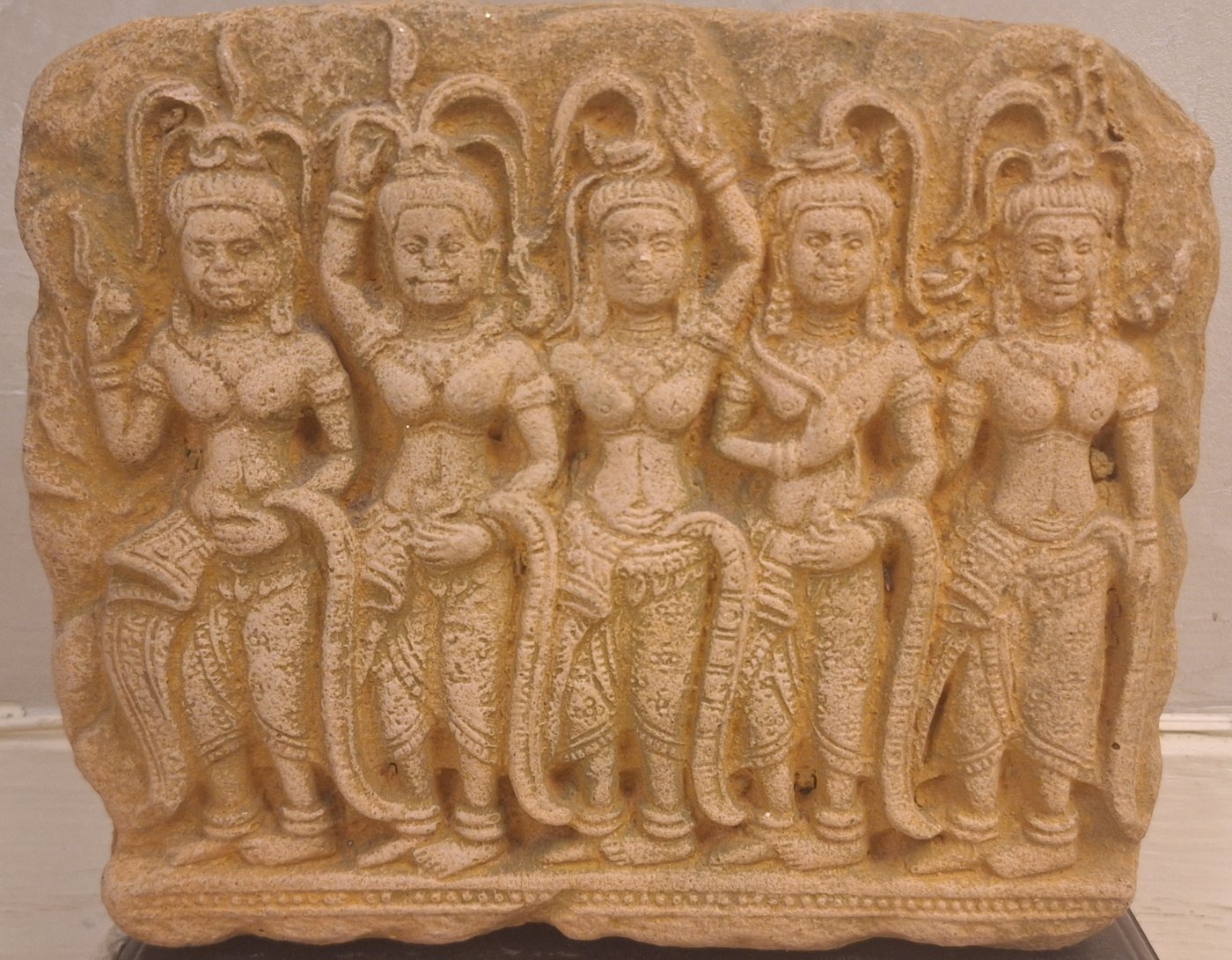 Sandstone frieze of five Apsara celestial dancers in classical Khmer style