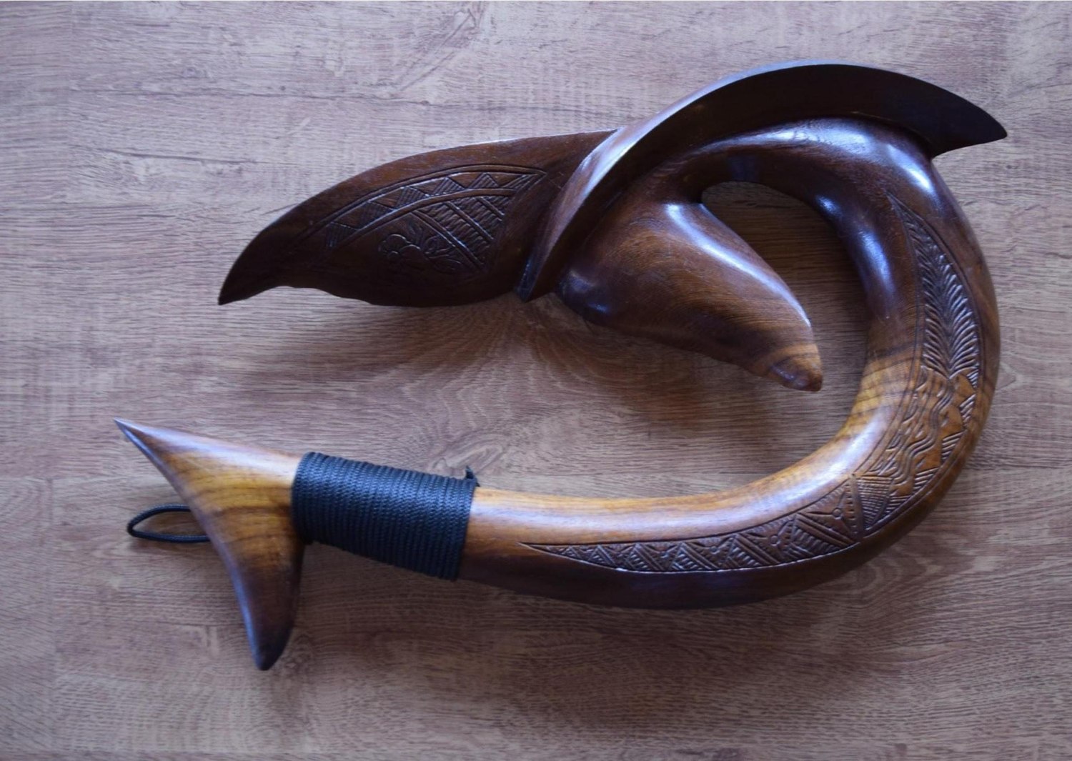 A Tongan Mata'u fish hook carved in the form of a whale's tail