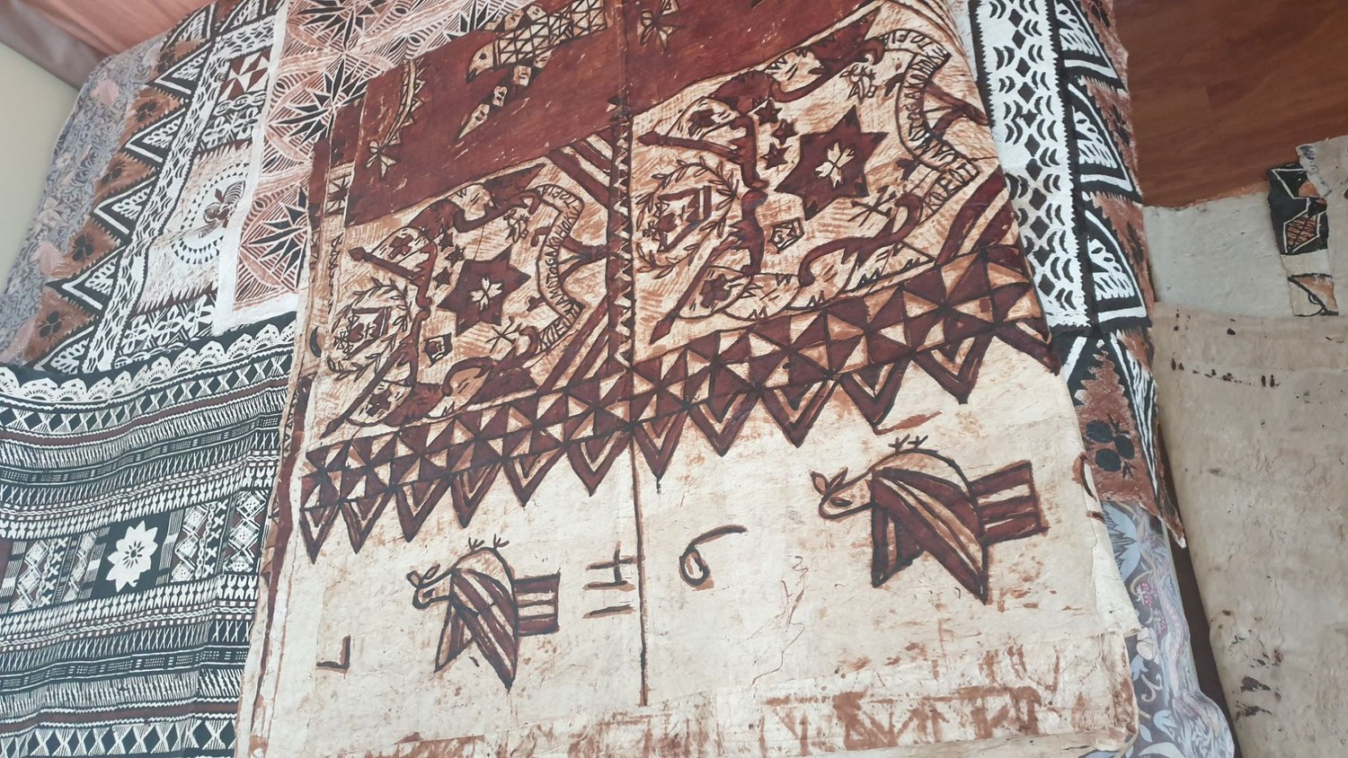 A large Tongan tapa (barkcloth) with star medallions and geometric borders